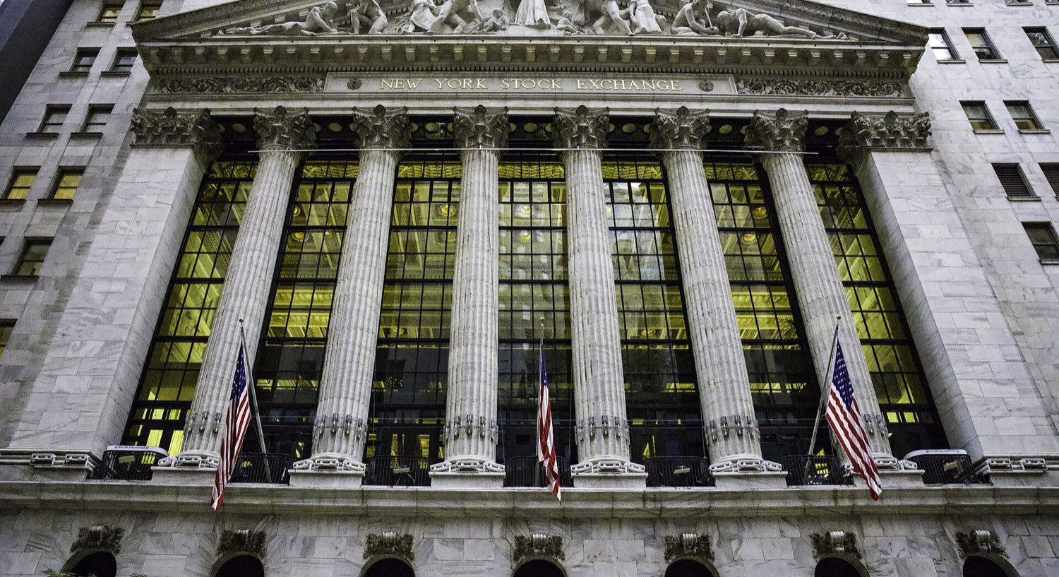 The facade of a stock exchange at dusk